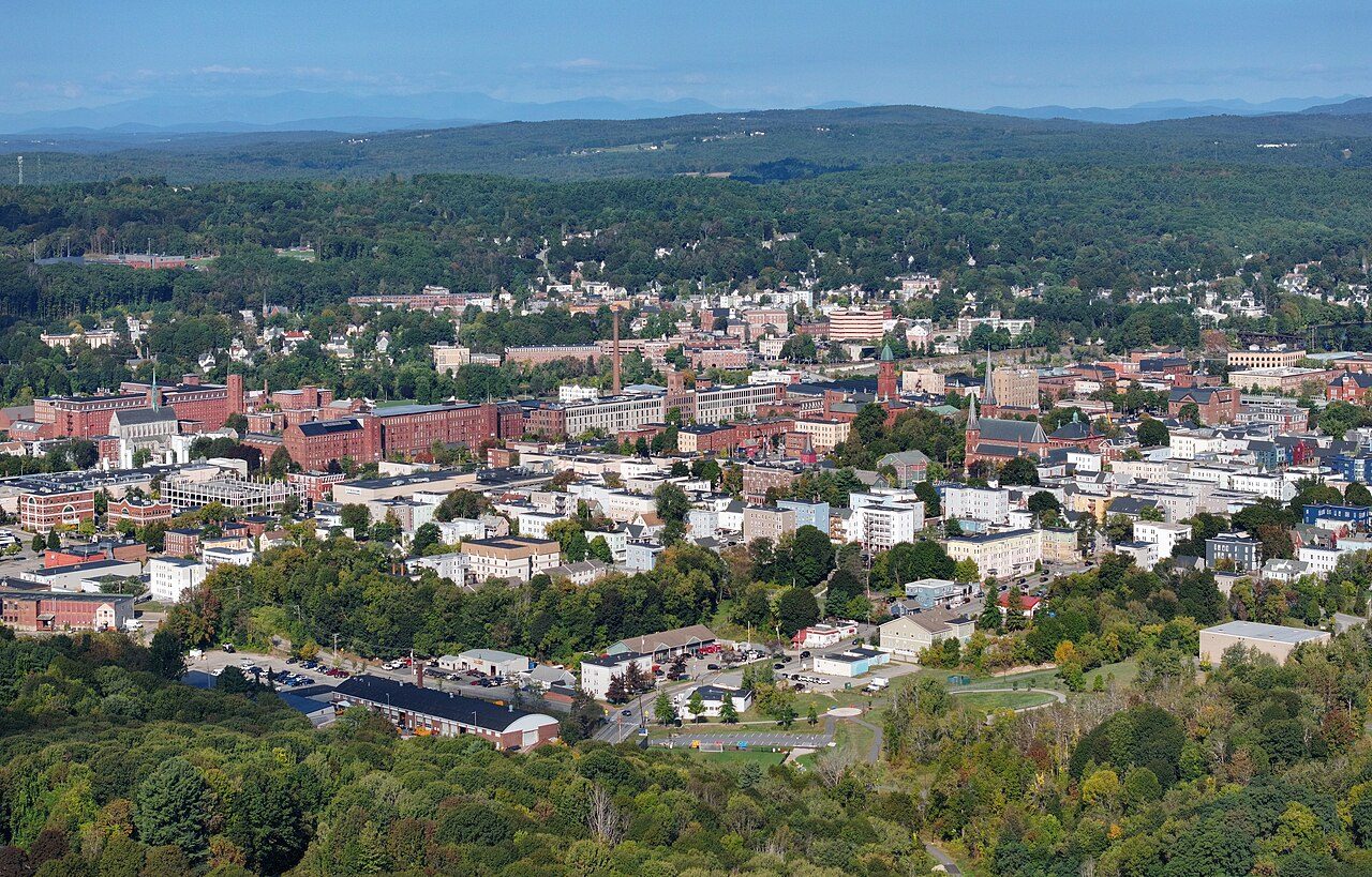 Skyline of Lewiston, Maine, with church spires and former mill buildings along the Androscoggin River