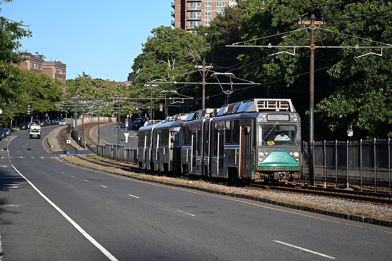 An outbound MBTA Green Line B branch train on Commonwealth Avenue near Boston College
