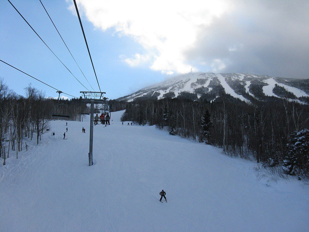 Sugarloaf's snow-covered summit and trails seen from the Whiffletree lift area