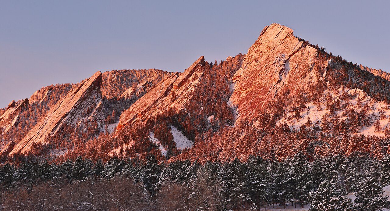 The Flatirons rock formations above Boulder at sunrise