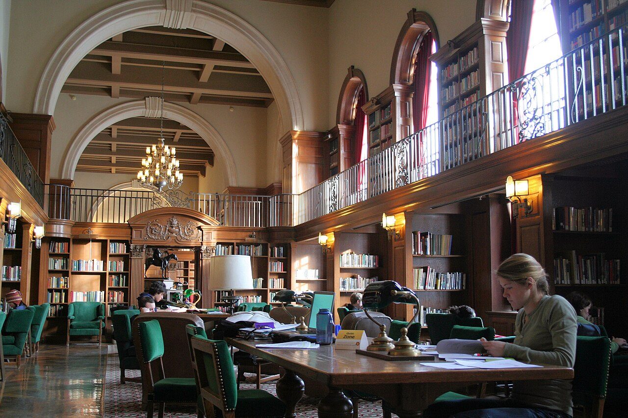 Wood-panelled Tower Room with reading tables inside Baker Memorial Library