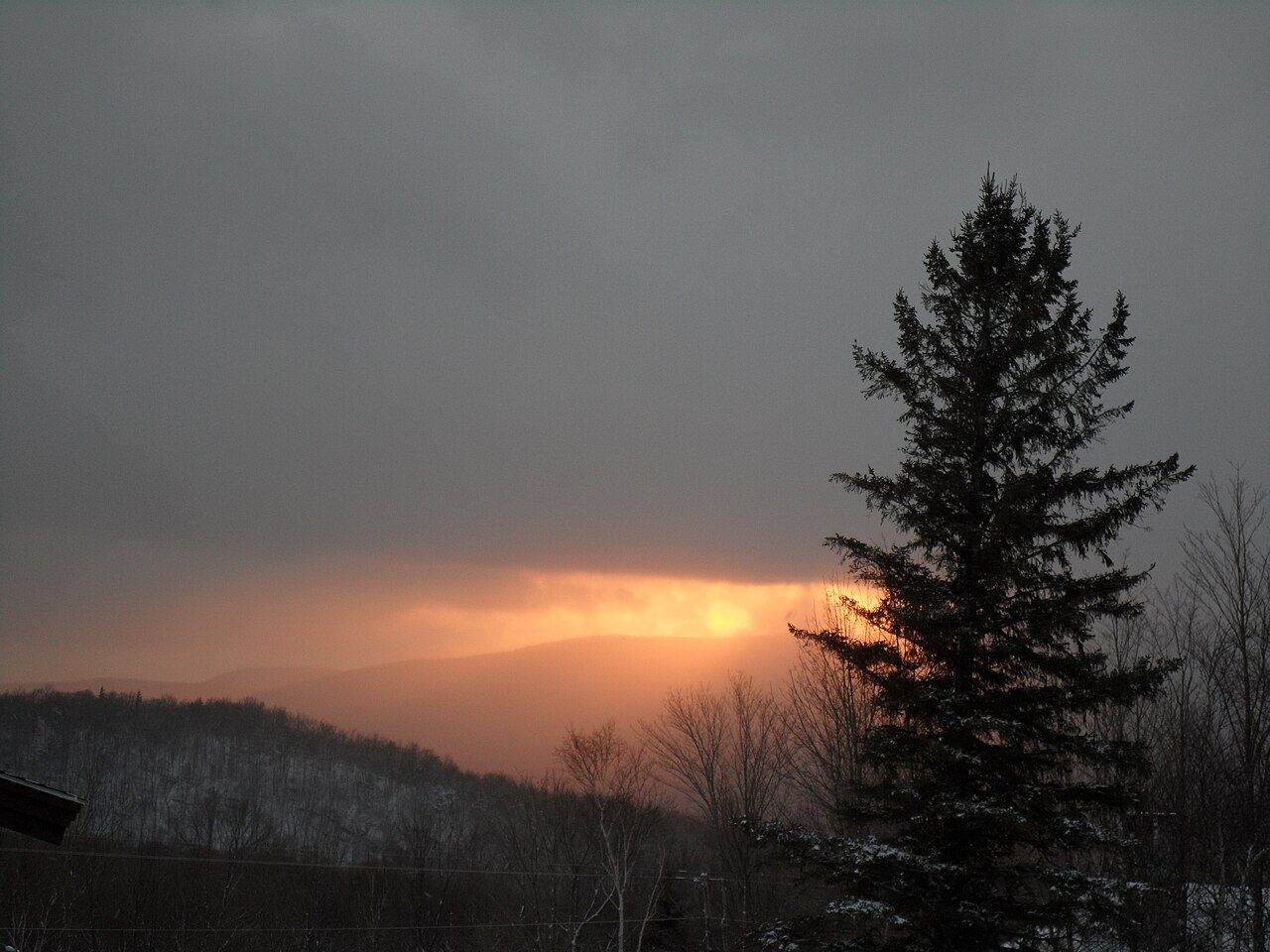 Snow-covered Cannon Mountain in Franconia Notch at sunset