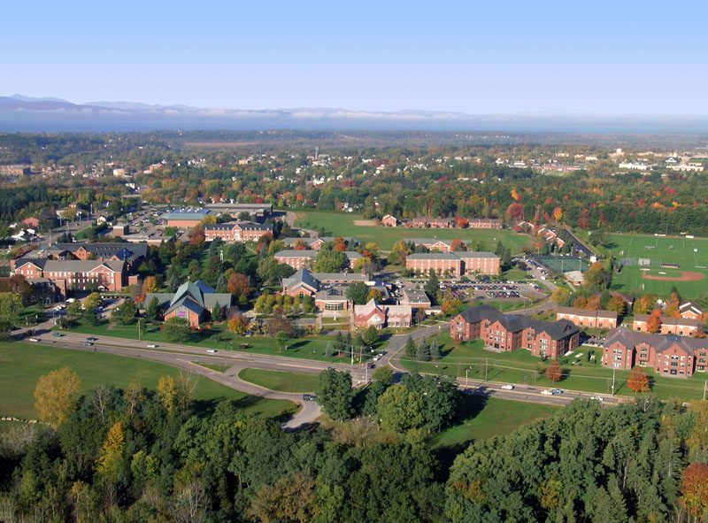 Aerial view of the Saint Michael's College main campus with Lake Champlain and the Adirondacks behind